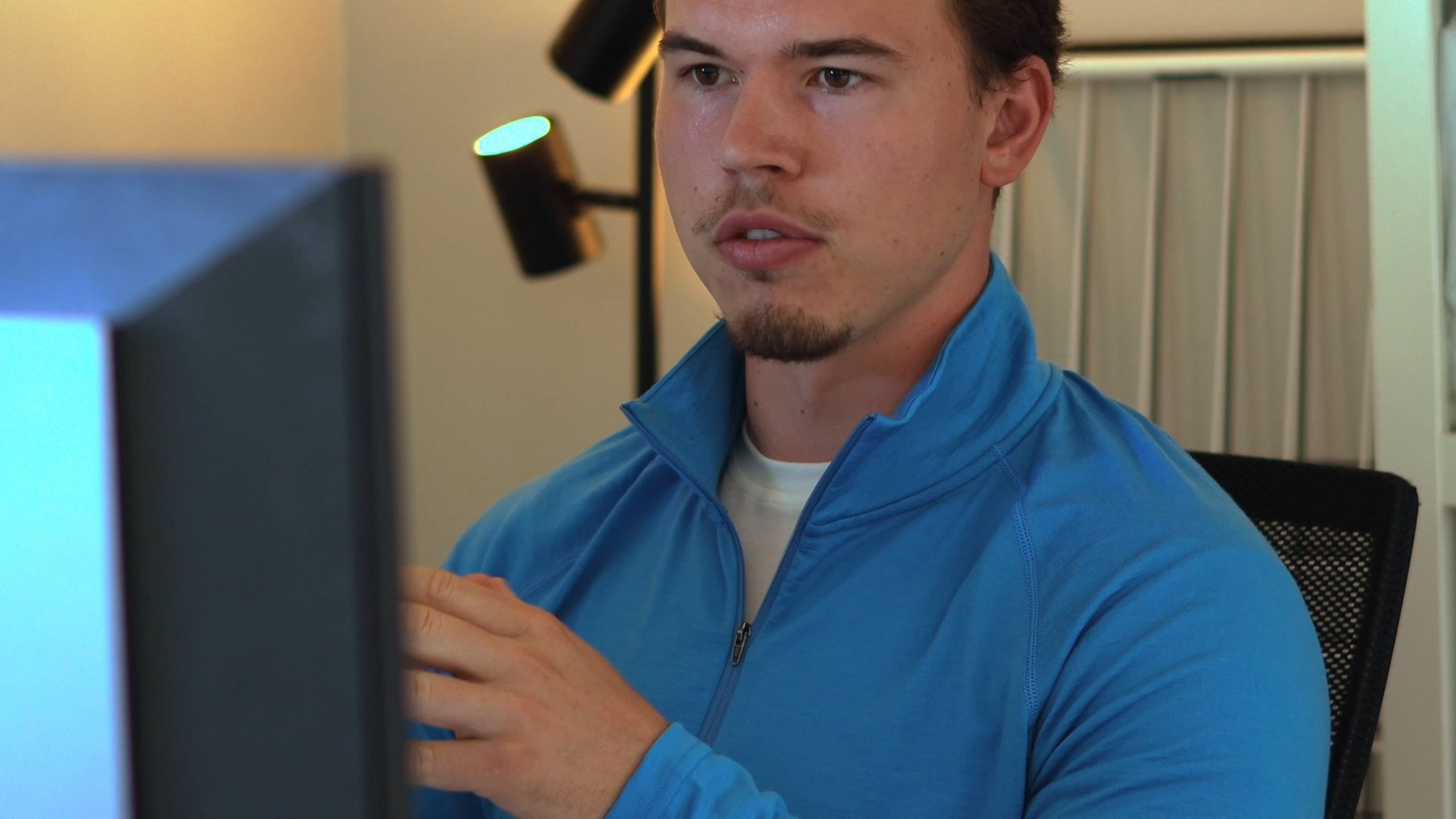 At the desk in the quarter zip